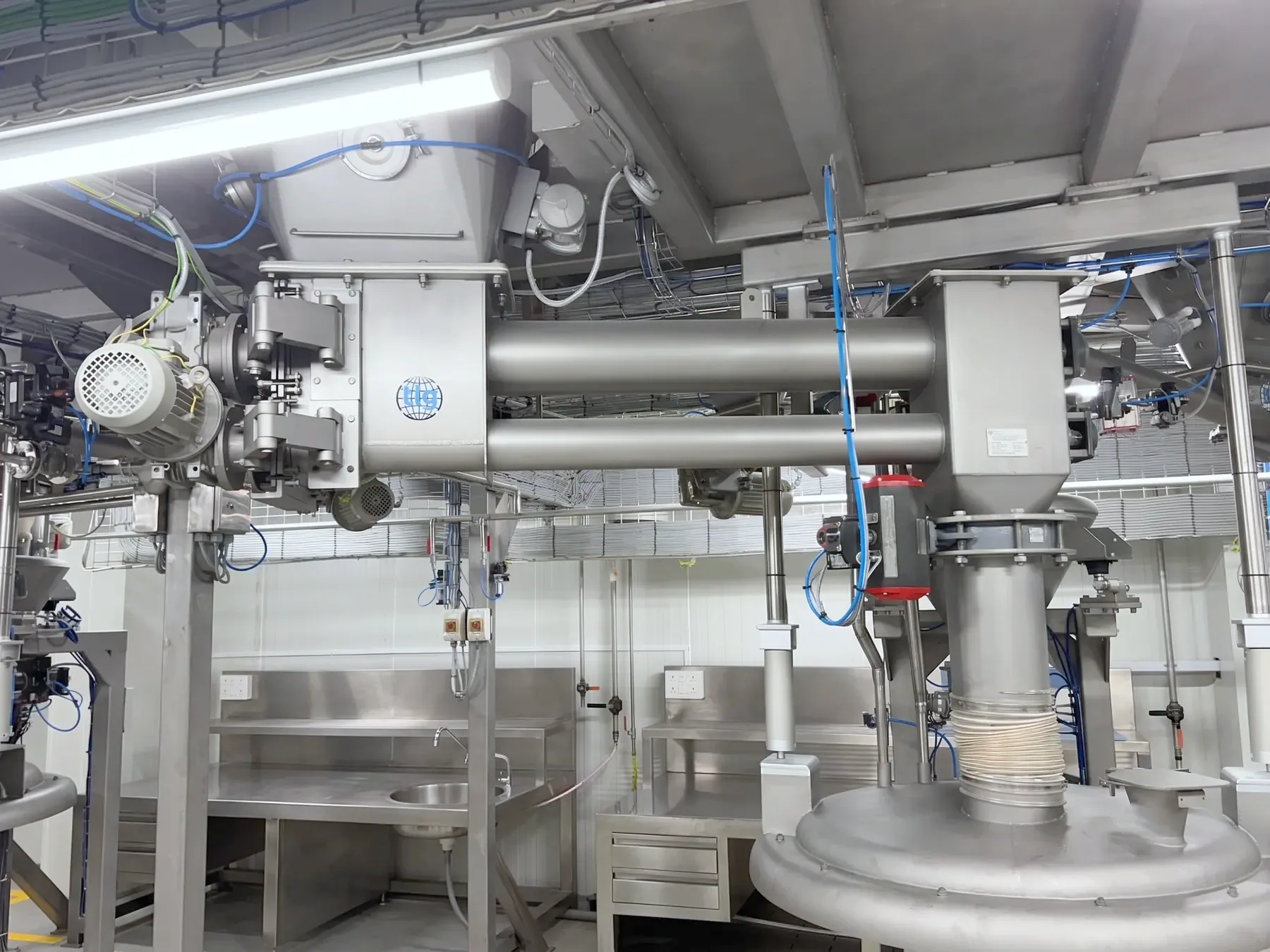 A pair of TLG tube screw conveyors running between process vessels